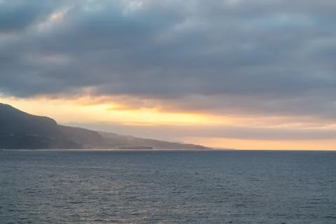 A cloudy sunset over the Atlantic Ocean in Puerto de la Cruz, Tenerife Stock Photos