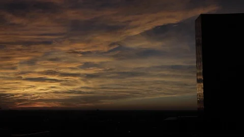Cloudy Sunset over City with tall office building Stock Footage 102404340