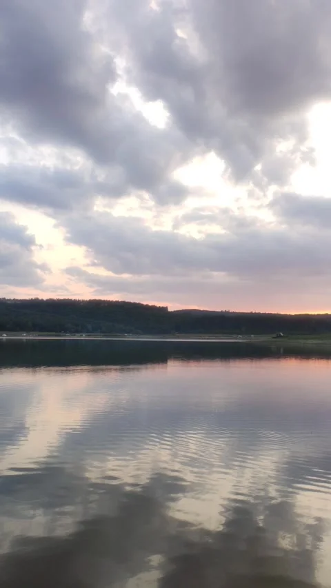 Cloudy sunset over a dam Stock Footage 249621723