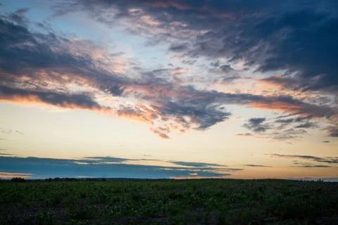 Cloudy sunset over fields summer evening photo Stock Photos