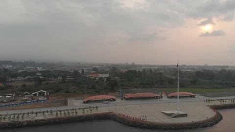 Cloudy sunset over highway and Malabo seaside with the flag of Equatorial Guinea Video stock 129955830