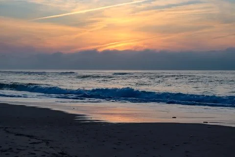 Cloudy sunset over the ocean and a little beach 스톡 사진