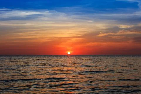 Cloudy sunset over the ocean Stock Photos