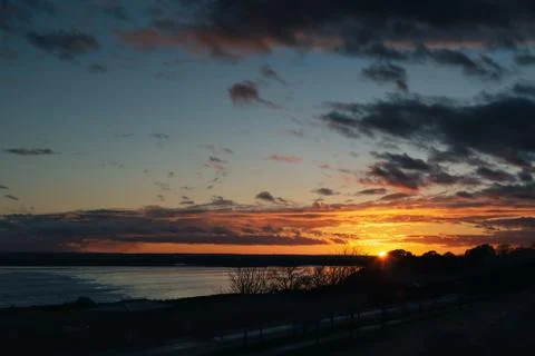 Cloudy sunset over Pegwell Bay, Kent. The sun can be seen with sun rays Stock-Fotos