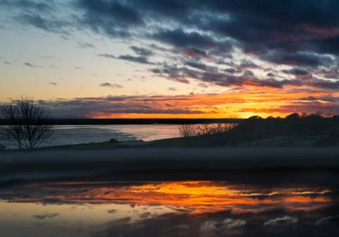 Cloudy sunset over Pegwell Bay, Kent with a foreground reflection Stock Photos