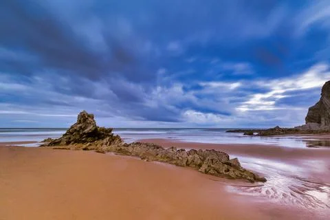 Cloudy sunset over a rugged Atlantic beach - A long-exposure shot of a dram.. Stock Photos