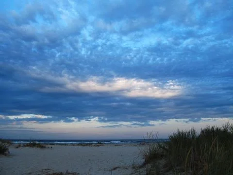 Cloudy sunset over the sea. Stock Photos