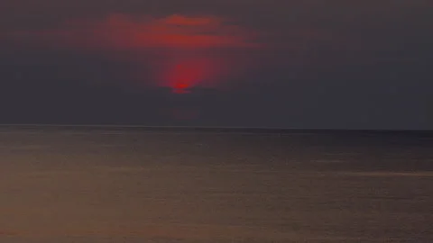 Cloudy sunset over a serene calm sea Stock Footage 303833445