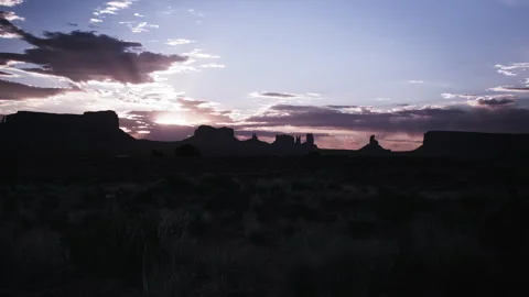 Cloudy sunset over Utah Monument Valley Desert landscape at twilight Stock Footage 310299836