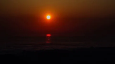 A cloudy sunset in the sea timelapse. Sun movement Stock-Footage 83364609