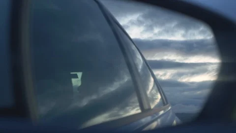 Cloudy sunset seen in the reflection of car mirror Stock Footage 122753047