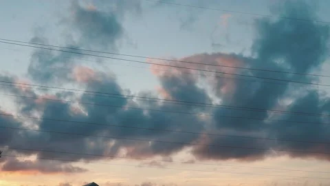Cloudy sunset summer sky with dark rain clouds moving fast in time lapse Stock Footage 163185511