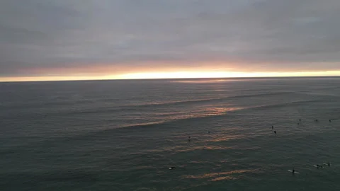 Cloudy Sunset with Surfers drone footage Stock Footage 162437136