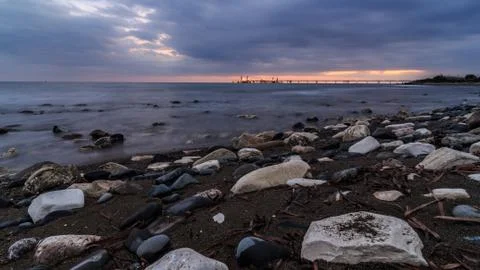 Cloudy sunset weather by the beach Stock Photos