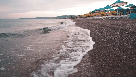 Cloudy time on empty beach with waves. Video stock 112266746