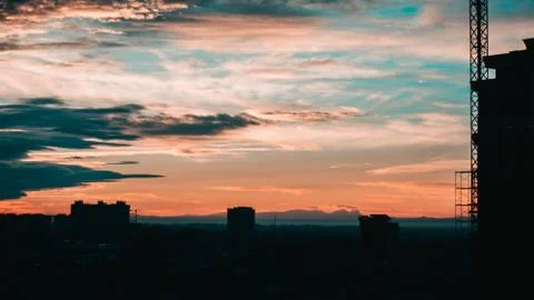 Cloudy urban sunset Stock Photos