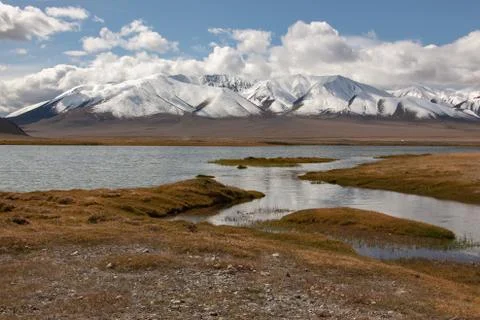 Cloudy view on a mountain lake. Mongolia snow hills 스톡 사진