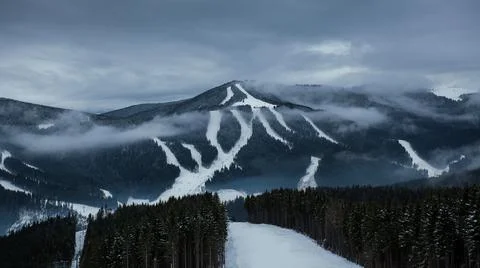 Cloudy view on a ski resort in winter mountains Stock Photos