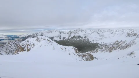 Cloudy view on top of mountains in the alps in winter time Stock Footage 100053898
