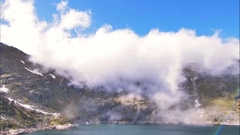 Cloudy waterfalls over a Lake Stock Footage 122238388