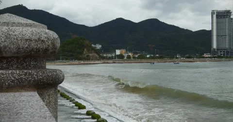 Cloudy weather, rain, large gray clouds, gloomy weather, sea waves break on the Stock Footage 144144790