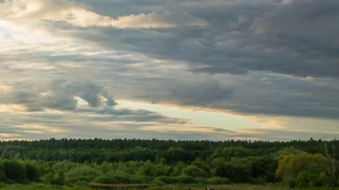 Cloudy weather, sunset over nature, green trees, summer, timelapse Stock Footage 160366288