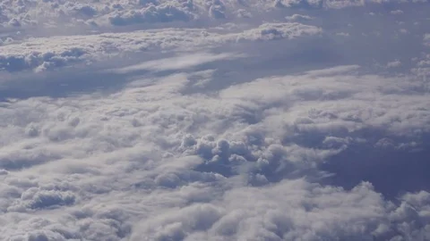 Cloudy weather system seen from above through the window of a commercial jet Stock Footage 82093433