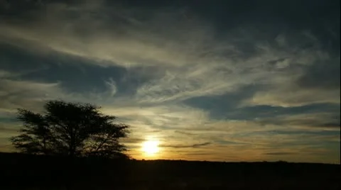 CLOUDY WHISPY SUNSET Stock Footage 9026594