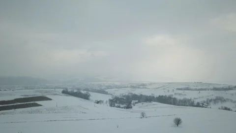 Cloudy winter day, snow falls. View of mountain village Stock Footage 114651705
