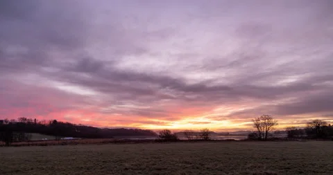 Cloudy Winter Sunset over Wild Grass and Fields with Blue Sky in Stock Footage 169249009