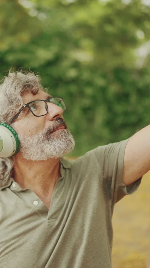 Clouse-up, friendly middle-aged man with gray hair and beard wearing casual Stock Footage 227022851