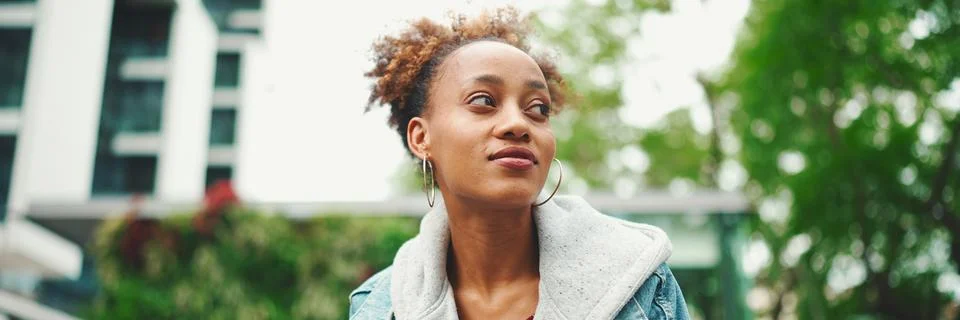 Clouse-up of nice young African American woman with ponytail in denim jacke.. Stock Photos