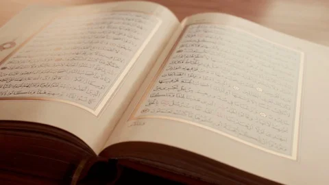 Clouse Up opened Quran on the table Stock Footage 101387865