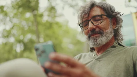 Clouse-up, positive middle-aged man with gray hair and beard wearing casual Stockbeeldmateriaal 226501243