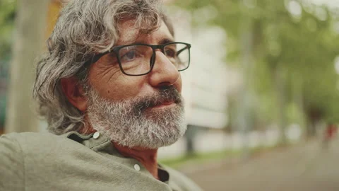Clouse-up, smiling middle-aged man with gray hair and beard wearing casual Stock Footage 227029534