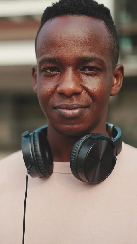 Clouse up, smiling young african student stands outside of university in Video stock 226936211