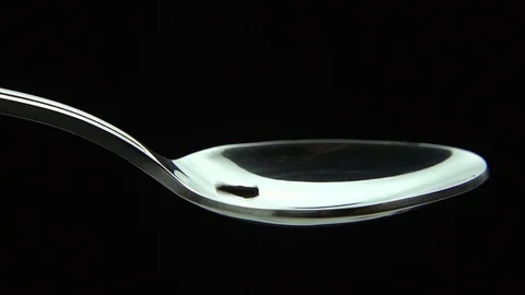 Clove dried spicy falling down into a spoon, slow motion Stock Footage 83035760