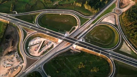 Cloverleaf Highway Interchange with Construction and Green Land Stock Footage 296510128