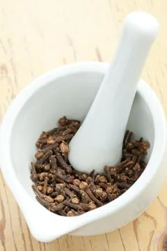 Cloves in ceramic mortar Stock Photos
