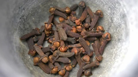 Cloves Falling into Kitchen Mortar Slow Motion Stock Footage 146808854