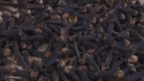Cloves falling onto wooden table Stock Footage 279528234