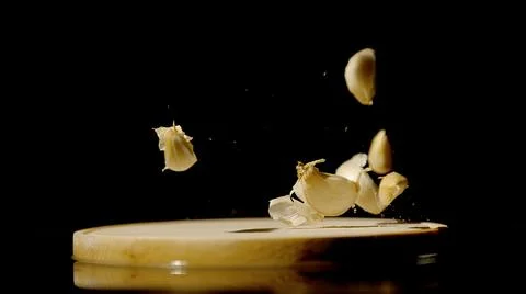 Cloves of garlic fall on the table Stock Photos