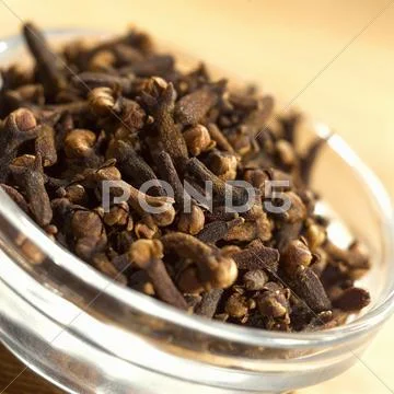 Cloves in glass dish (close-up) Stock Photos