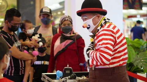 Clown blow the balloon until explode Stock Footage 221387464