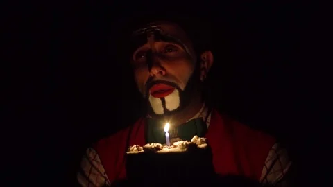 Clown in the dark with a cake Stock Footage 85017702