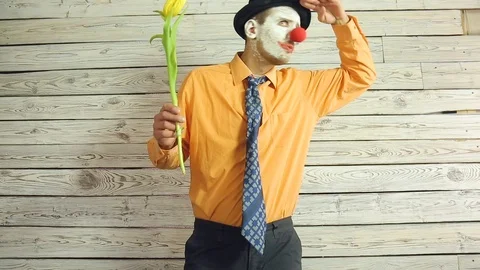 Clown with flowers in hand Stock Footage 108445425