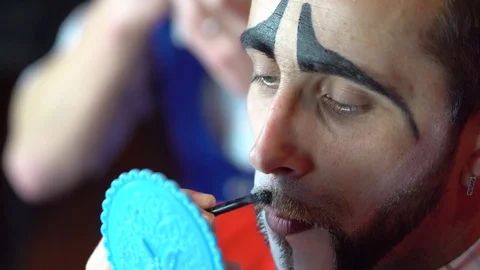 The clown paints a mustache Stock Footage 84642116