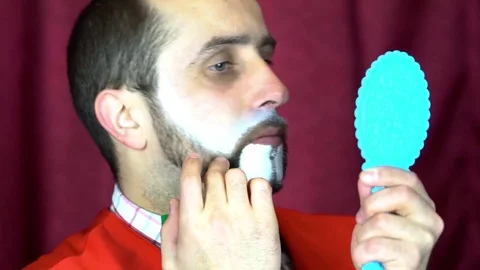Clown puts a makeup on her face Video stock 84636297