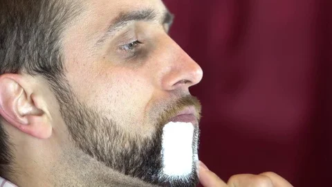 Clown puts makeup on his beard Stock Footage 84636275
