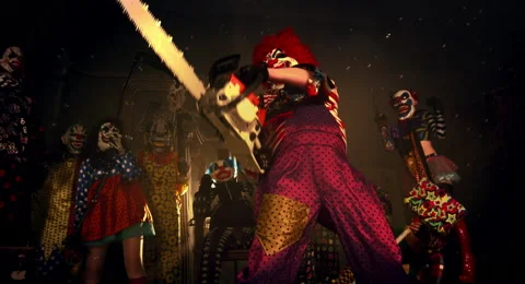 The clown in the red wig standing with a chainsaw. Stock Footage 67871291